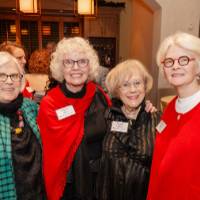 Four women standing together and smiling for camera, including First Ladies Haas, Lubbers, and Murray